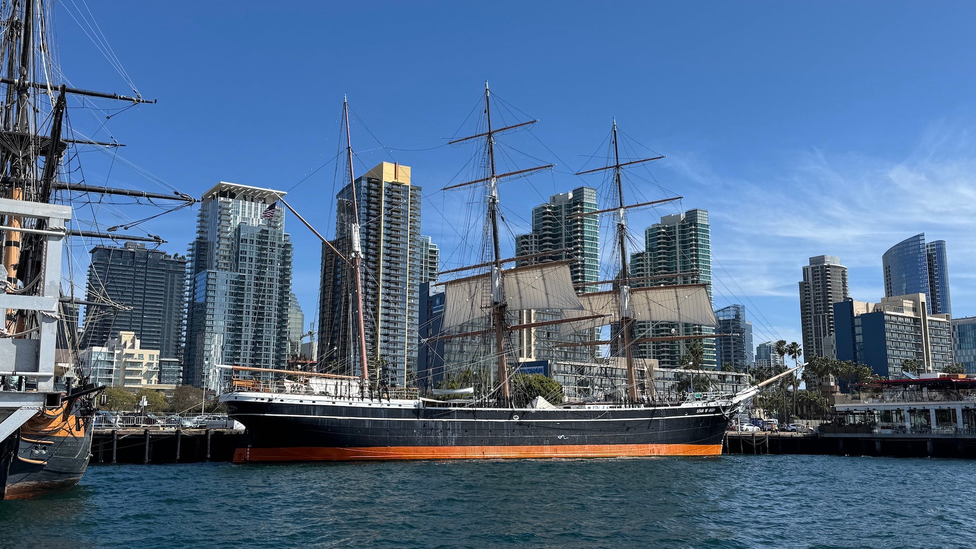 Exterior shot of the Star of India ship with the San Diego skyline in the background